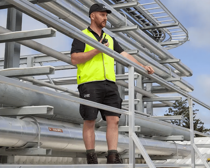 Silver Fern Farms employee onsite using a Tait portable radio to stay connected with their new Tait OpenTrunk system