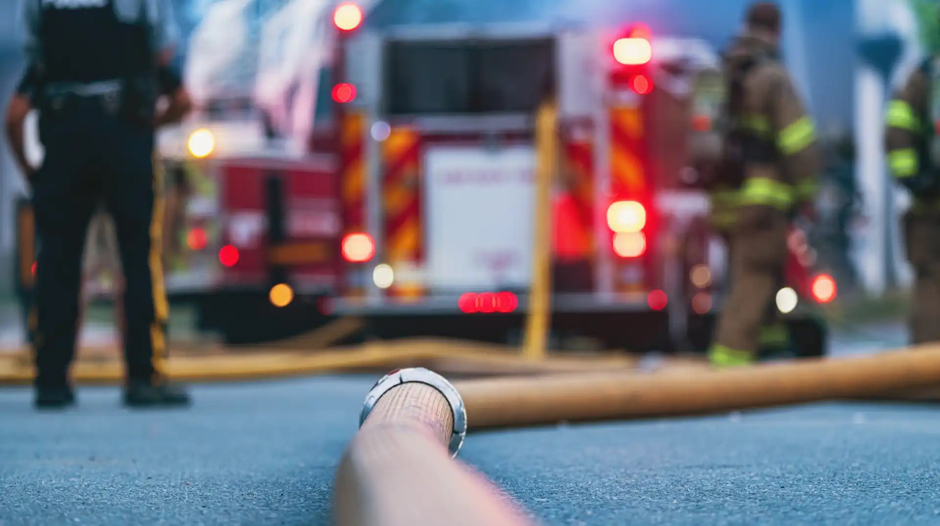 Firefighters and emergency vehicles at an incident scene, highlighting the importance of trusted information and AI-assisted decision support