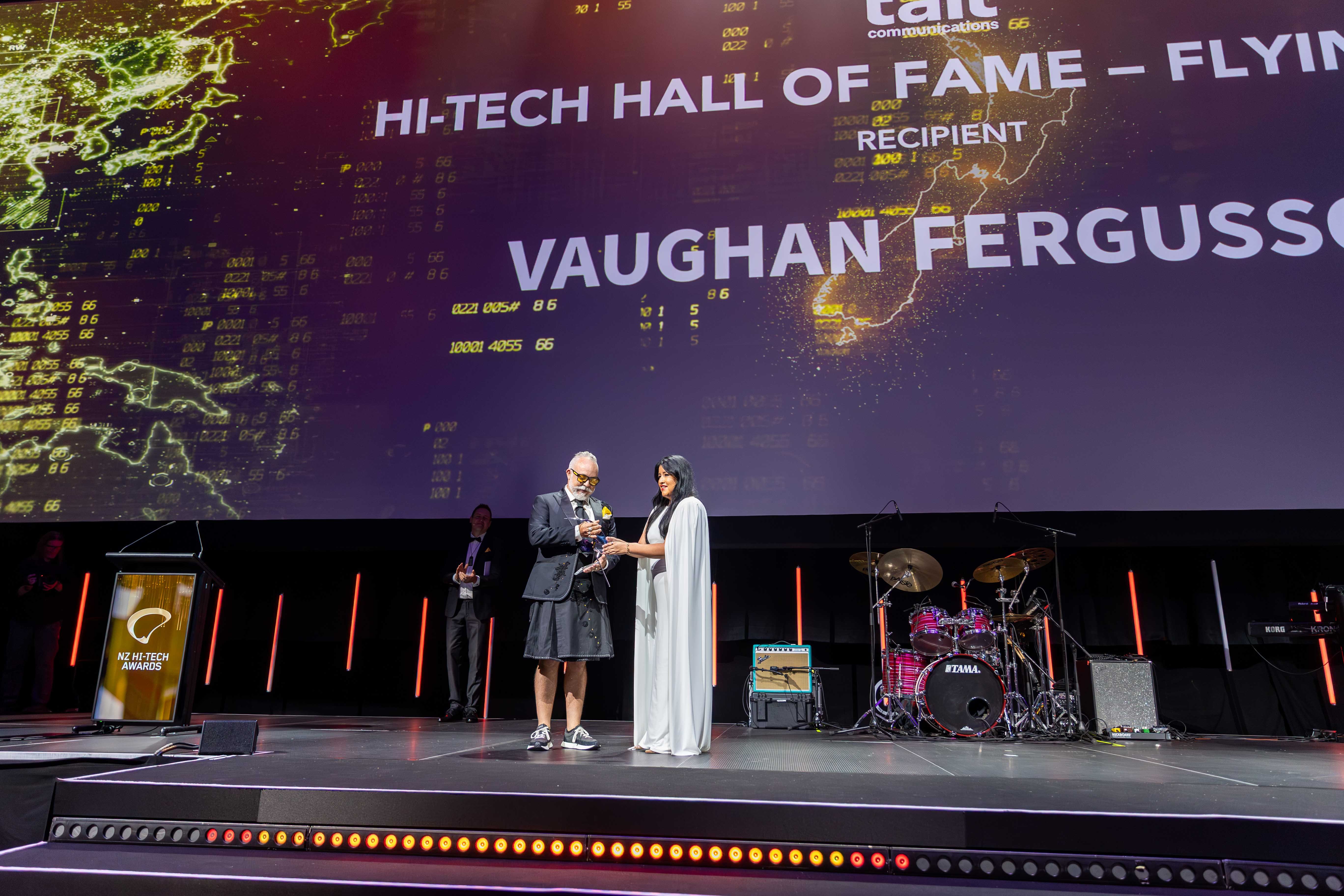 Tait CMO Maria Rowe presenting the Flying Kiwi to Vaughan Fergusson