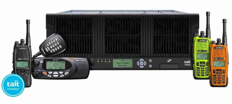 Images of Harris-Tait 9400 P25 Series Radio Family (left to right): TP9400 Portable in black (limited keypad in black), TM9400 Mobile unit with full keypad mic, TB9400 Base Station Repeater, TP9400 Portable in high-visibility lime-green (full keypad in black) and TP9400 Portable in orange (full keypad in black).